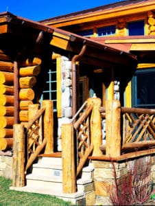 Covered porch and deck stair on a custom log home in Colorado