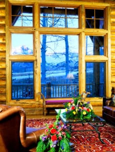 Vaulted great room with timber trusses in a Frontier Log Homes luxury log home