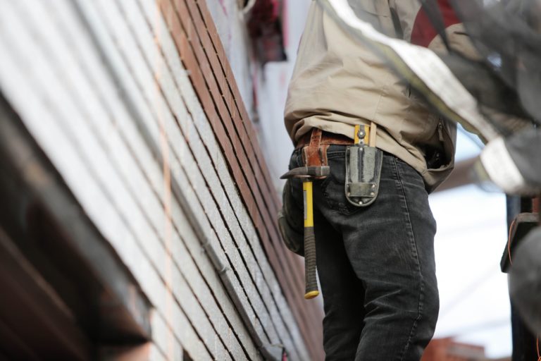How much does a general contractor charge — Frontier Log Homes crew on a Colorado build site