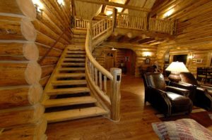 Handcrafted log staircase to the second floor, detailed to allow for settling