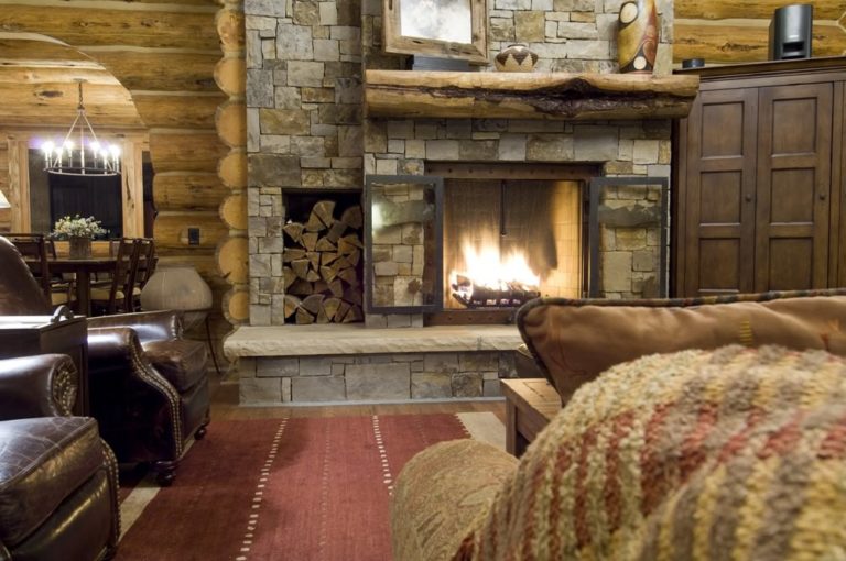 Fireplace ideas for a log home with a stone hearth and log walls