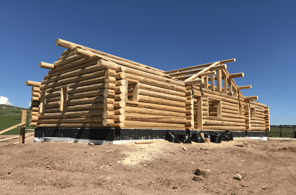 A log cabin under construction. Logs are made of natural wood. 