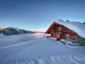 Cabin insulation at work: a log home in deep snow staying warm through a Colorado winter