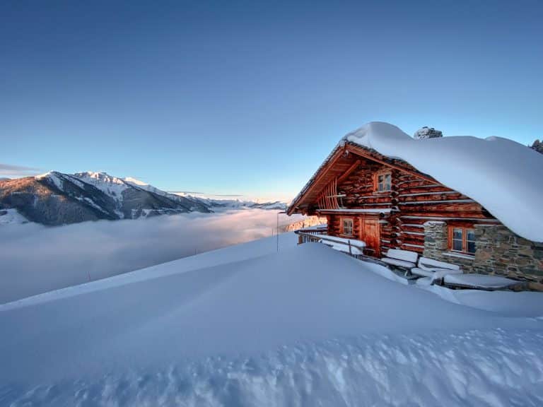 Cabin insulation at work: a log home in deep snow staying warm through a Colorado winter