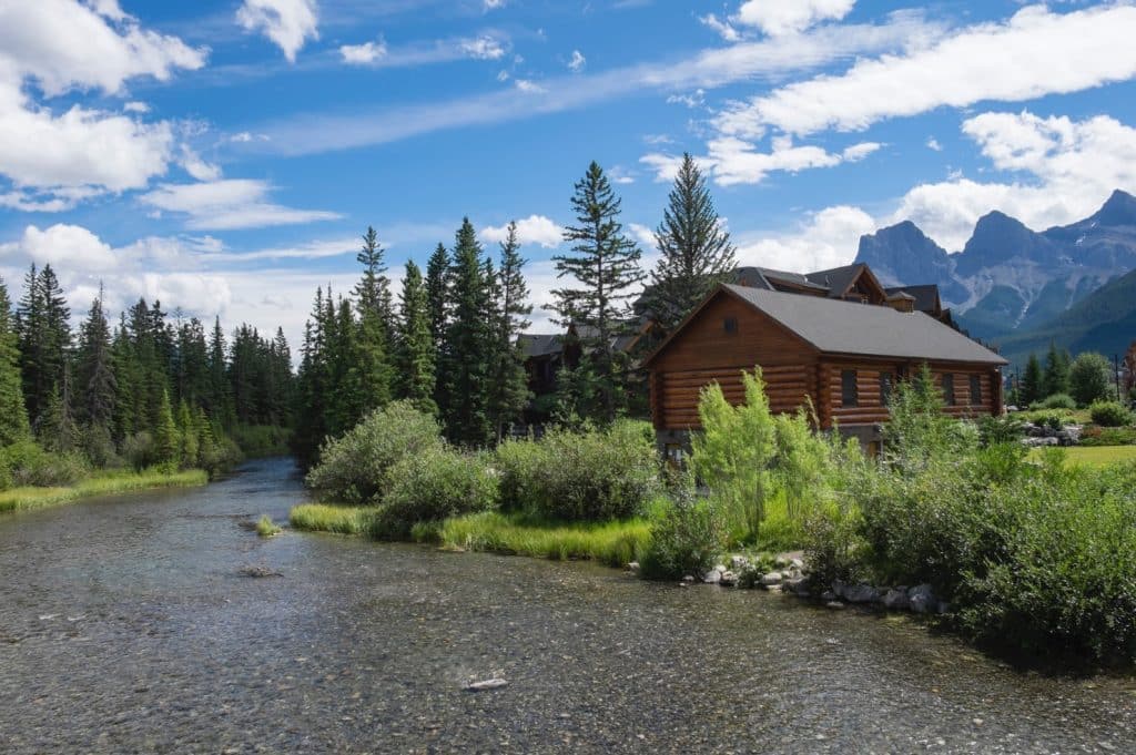 An energy-efficient off-grid home surrounded by a beautiful nature built next to the river | Frontier Log Homes