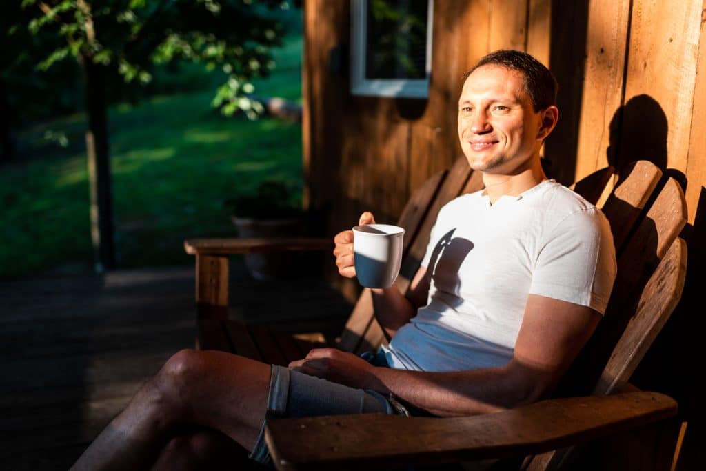Summer cooling on a shaded log cabin porch during a hot afternoon