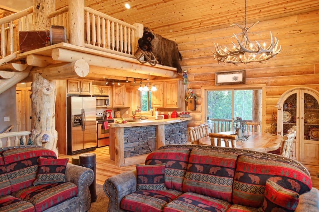Log cabin lighting in a great room with layered ceiling and task fixtures