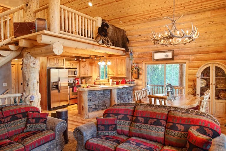 Log cabin lighting in a great room with layered ceiling and task fixtures