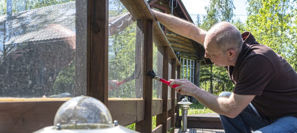 Spring log home maintenance inspection on a handcrafted cabin