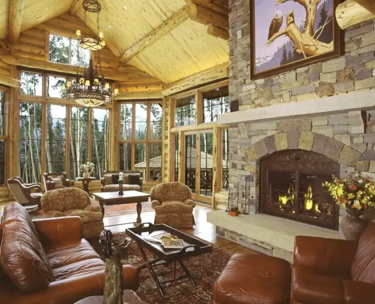 Log home great room and living area with exposed logs — photo 32