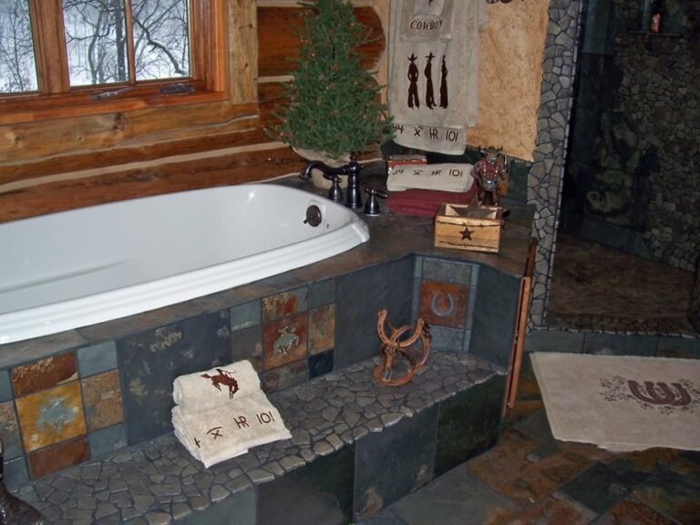 Log home bathroom in a custom handcrafted log house — photo 13
