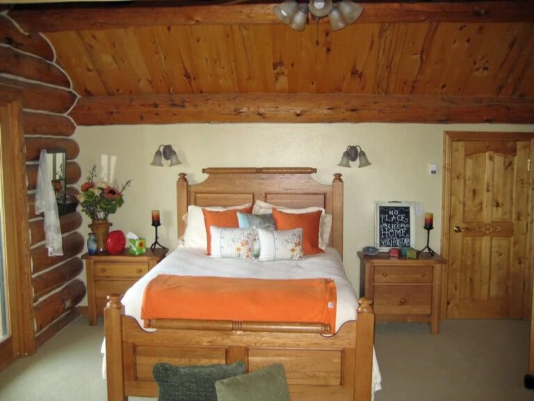Log cabin bedroom in a custom log home — photo 12