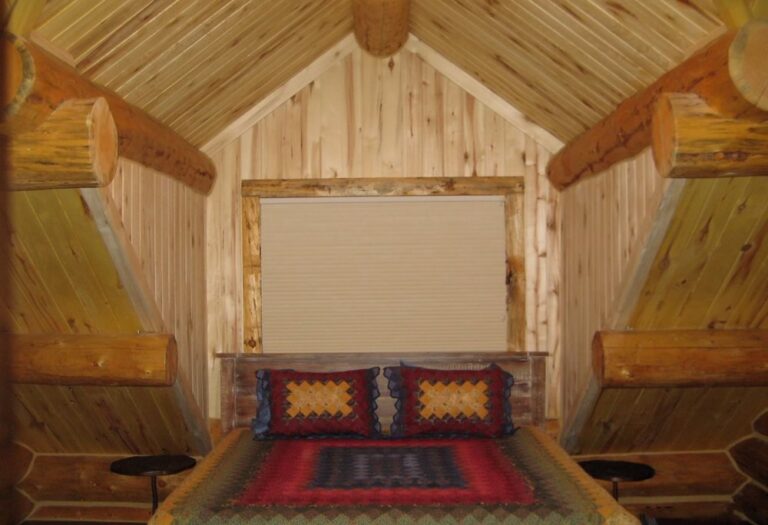Log cabin bedroom in a custom log home — photo 10