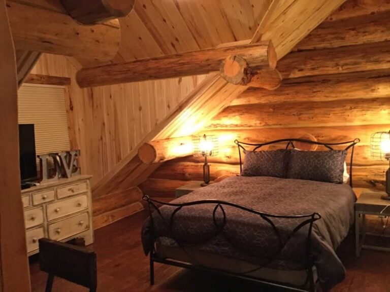 Log cabin bedroom in a custom log home — photo 8