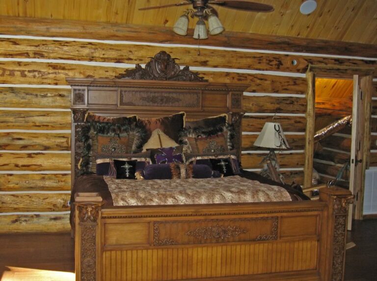 Log cabin bedroom in a custom log home — photo 4