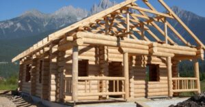 A timber frame shell being raised on site, where timber frame homes cost less in labour hours